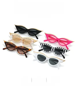Detail shot of vintage cat-eye sunglasses with gold metal wing accents in six colors