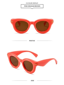 Pink orange puffy oval sunglasses with brown lenses and side golden metal dot details