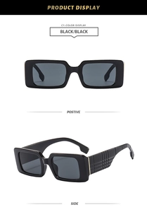 Detail view of black rectangular sunglasses with textured grid pattern on wide temples