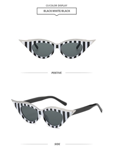 Detail view of retro cat-eye sunglasses featuring unique black and white vertical stripes