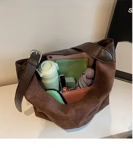 Interior view of brown suede bucket bag showing spacious storage for tablet and umbrella