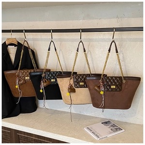 Detail of four colorful tote bags with quilted texture, metal locks, and cute charms