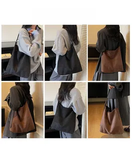 Close-up of vintage suede bucket bags in brown and black showing the shoulder strap detail