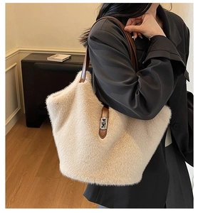 Détail d'un sac seau beige en peluche avec bandoulière marron et fermoir rotatif en métal