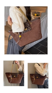 Detail of coffee brown suede tote bag with diamond lattice pattern and gold chain strap
