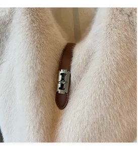 Close-up of silver twist lock and premium plush faux fur texture on the tote bag