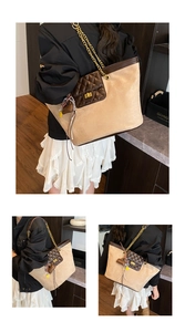 Detail of khaki suede tote with diamond quilt pocket, gold chain and bag charms