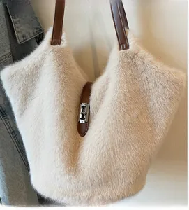 Detail of plush beige tote bag showing soft faux fur texture and brown leather strap
