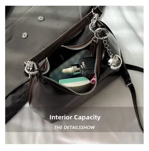 Interior storage capacity of the brown crescent shoulder bag with cosmetics and makeup