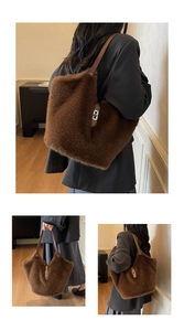 Detail of dark brown faux fur tote bag with leather strap and silver metal buckle
