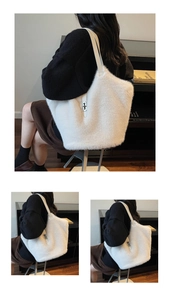 Detail view of large white plush tote bag showing soft faux fur and silver twist lock
