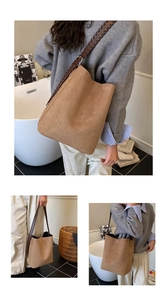 Close-up of brown suede tote bag featuring unique wide braided leather shoulder straps