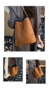 Close-up of brown suede bucket bag featuring a detailed woven shoulder strap design