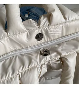 Detail of cream white quilted bag with hidden magnetic clasp and metal zipper closure