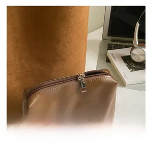 Detail of high-quality silver metal zipper on vintage brown leather shoulder bucket bag