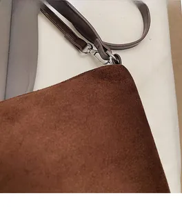 Detailed close-up of high-quality brown leopard tote bag suede texture and metal hook