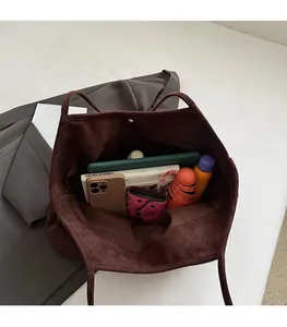 Interior view showing the large storage capacity of the dark brown suede tote bag
