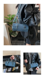 Detail of dark blue cylinder bowling bag with adjustable straps and metallic accents