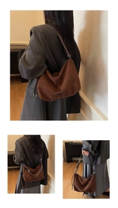 Detail of dark brown faux suede hobo bag showing texture and embossed logo patch