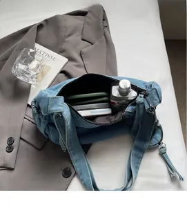 Detailed view of the large capacity blue denim tote bag interior with zipper closure