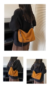Detailed view of caramel suede shoulder bag with elegant silver chain strap and minimalist logo