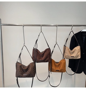 Detail of multi-color Hobo tote bags showing metal chains and adjustable straps