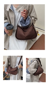 Detailed view of brown suede stitching on retro crossbody bag with golden hardware