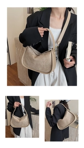 Detail view of the suede bowling bag with adjustable strap and smooth leather stitching