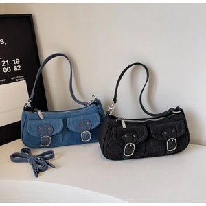 Detail of denim shoulder bags with multi-pocket design and adjustable spare straps