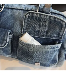 Detail view of denim tote bag showing side utility pockets and washed fabric texture
