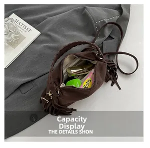 Internal view of brown suede handbag showing capacity for lipstick and skincare