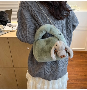 Detailed back view of a soft bean green faux fur bag with cute rabbit charm and metal chain