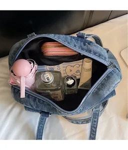 Spacious denim pillow bag interior showing organized storage for cosmetics and umbrella