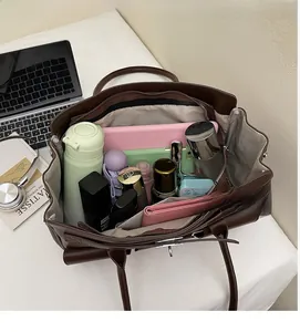 Macro view of spacious brown tote bag interior with multiple personal essentials