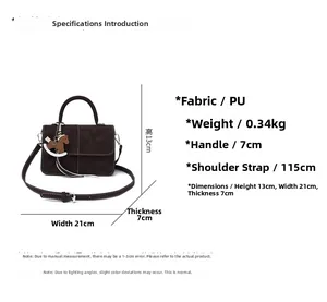Detail view of small square crossbody bag with dimensions and horse charm accessory