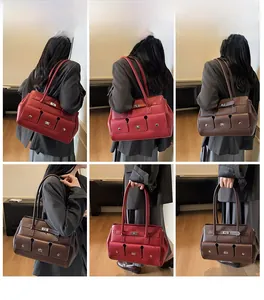 Detailed view of tote bag with three front pockets and metallic twist-lock buckles