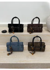 Detail shot of four color options of suede handbags with white contrast stitching accents