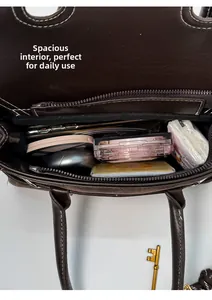 Top view of brown matte handbag interior showing spacious compartments and daily items