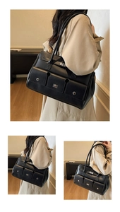 Close-up of black leather tote with silver twist locks and dual front pockets