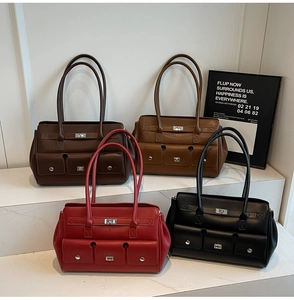 Chic shoulder bags in red, black, and brown displayed on marble steps with three front pockets