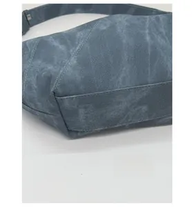 Detailed macro view of the reinforced base and thick canvas texture of a blue tote bag