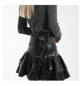 Gothic coffin-shaped shoulder bag with silver cross and metal chain details on a model