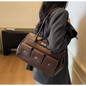 Detail of dark brown tote bag with rivet pockets and premium matte lychee texture