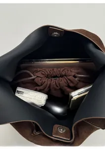 Interior view of large capacity dark brown suede bucket bag showing daily essentials