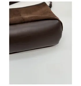 Detail of reinforced bottom base on dark brown frosted leather bucket bag for women