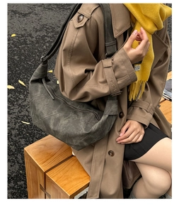 Deep grey vintage matte moon bag featuring a wide shoulder strap worn by a model outdoors