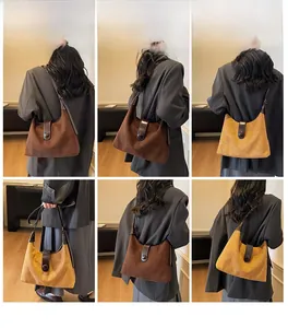 Detail view of vintage hobo shoulder bag with contrast leather trim and buckle closure