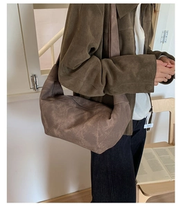 Close-up of a large coffee-colored suede hobo bag with a soft vintage matte texture