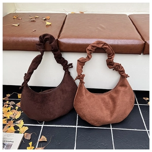 Detail of hobo bags with pleated scrunchie straps in dark coffee and light brown suede