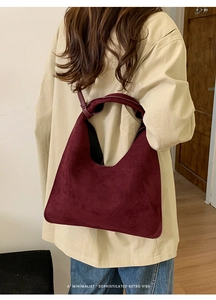Model view of burgundy minimalist large tote bag with elegant knot strap detail